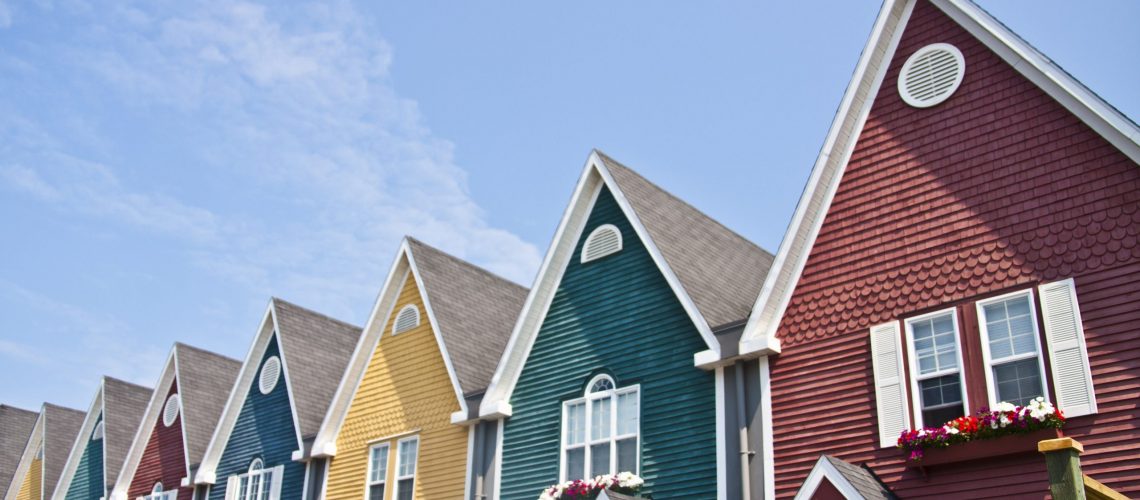 A row of colorful holiday homes by the seaside.